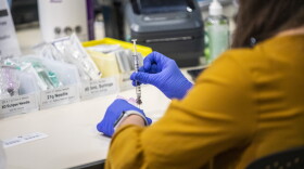 A healthcare worker prepares a Pfizer vaccine dose at a large-scale vaccination site at UNC's Friday Center in Chapel Hill Tuesday, Jan. 19 2021.