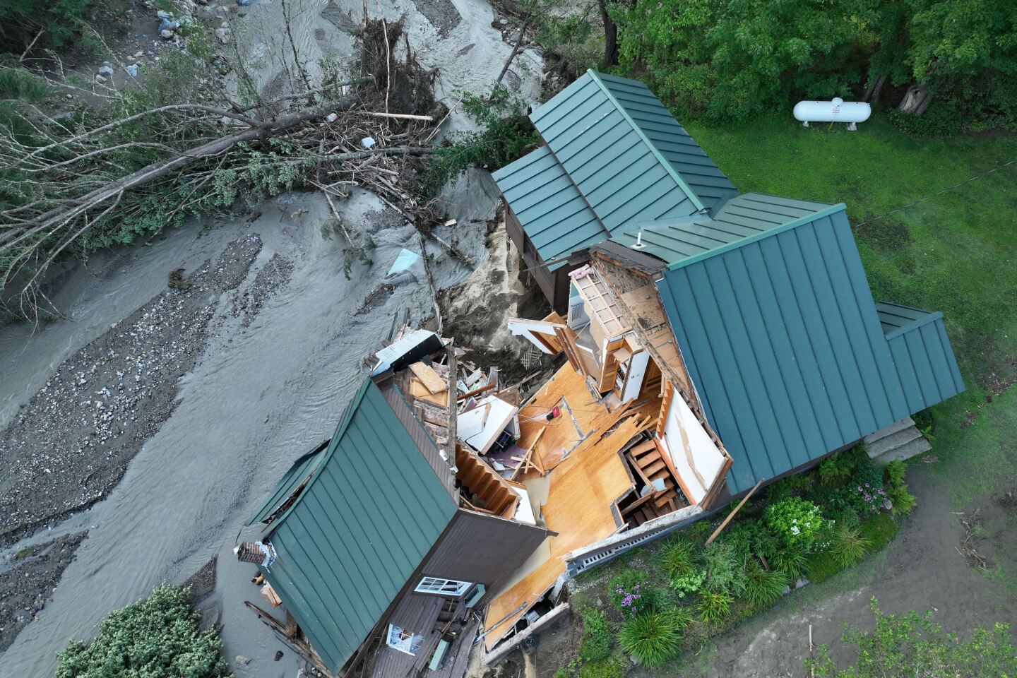 A home in Lyndon has split and fallen due to flash flooding on July 30, 2024.