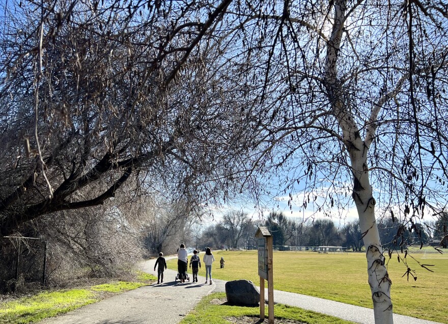 People walk along a trail at Leslie Groves Park in Richland, Wash.