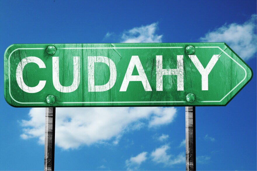 Cudahy's road sign on a blue sky background.