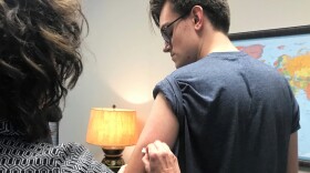 Nicholas Richter gets a measles vaccine shot from a nurse at a Louisville clinic.