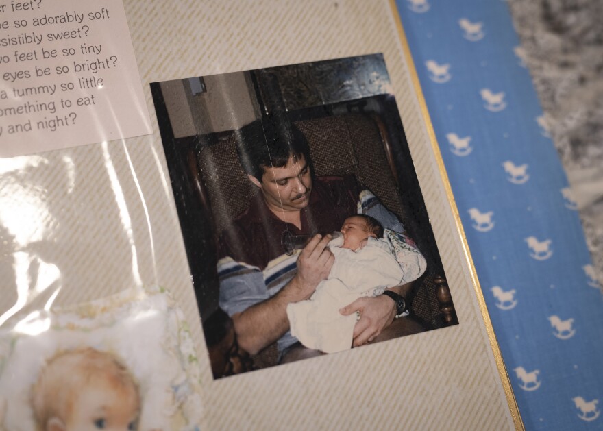 A photo of Larry Hobson holding his daughter, Heather Woock, as an infant. Woock's mother consulted with a fertility doctor when she was having trouble getting pregnant.