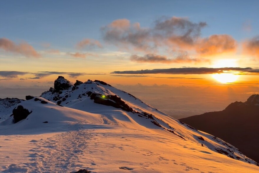 The hikers got to the top of Mount Kilimanjaro early in the morning as the sun was starting to rise.