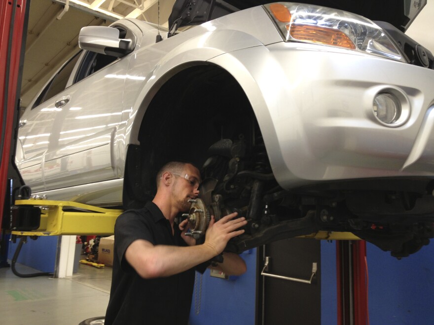 C.J. Forza, a student in the I-BEST program in Washington state, repairs a car for class at Shoreline Community College.