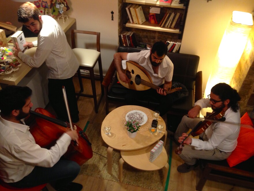 A trio of Syrian musicians performs at the opening of Pages bookstore in Istanbul. The store has a cafe and a play area for children, and owners hope to host movie screenings and workshops.