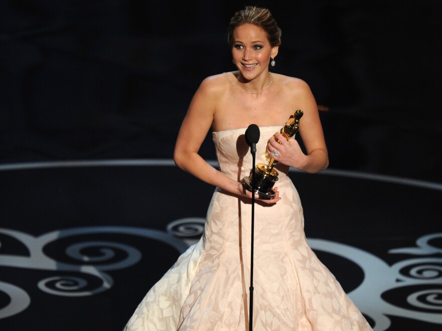 Jennifer Lawrence accepts the Oscar for best actress in <em>Silver Linings Playbook.</em>