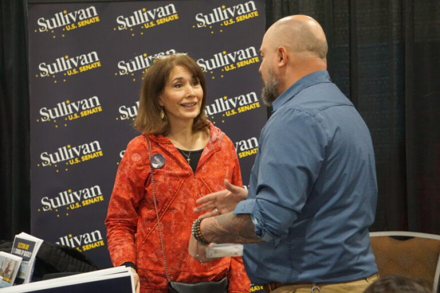 Julie Fate Sullivan, the wife of U.S. Sen. Dan Sullivan, R-Alaska, speaks to a supporter on Oct. 24. 2026, at the art fair set up at the Alaska Federation of Natives convention in Anchorage. The fair, which includes information booths as well as artists' work, is a regular feature of the annual convention. Sullivan is running for re-election, and his wife manned a campaign booth during the convention.