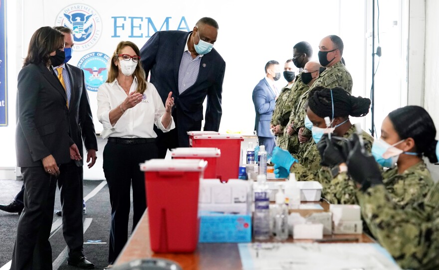 Vice President Kamala Harris, left, receives a vaccination center tour from FEMA's Gracie Szchech Monday, as Jacksonville Lenny Curry, left, and Rep. Al Lawson, fourth from left, look on.