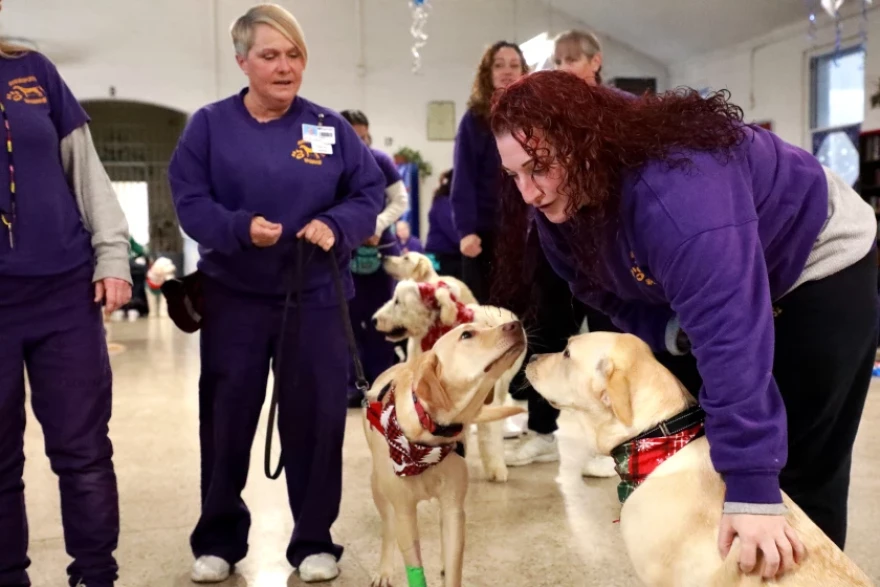 Amber Cannella, right, is one of 40 people working as primary or secondary dog trainers in Logan prison’s Helping PAWS program. “The dogs helped me heal,” says Cannella.
