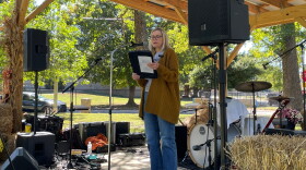 Indivisible Evansville President Wendy Bredhold speaks from the stage at Vote Fest in Evansville's Vann Park, Oct. 18, 2026