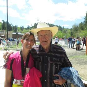 Angie Sewalson taking a picture with her grandfather, John Baumann, after finishing Finished a half marathon in Deadwood, SD.