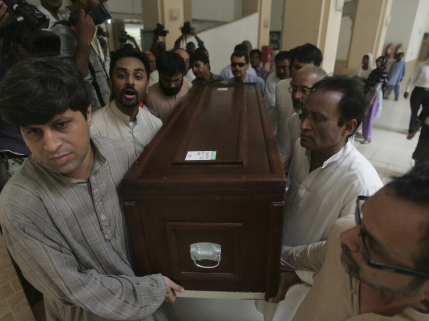 People carry the coffin of Pakistani journalist Saleem Shahzad at Karachi airport in Pakistan on June 1. In his final story, Shahzad quoted anonymous sources who linked an attack on a naval base to the discovery of suspected al-Qaida operatives inside the navy itself.