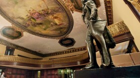 FILE - A statue of Thomas Jefferson, right, stands in New York's City Hall Council Chamber, July 14, 2010. (AP Photo/Richard Drew, File)