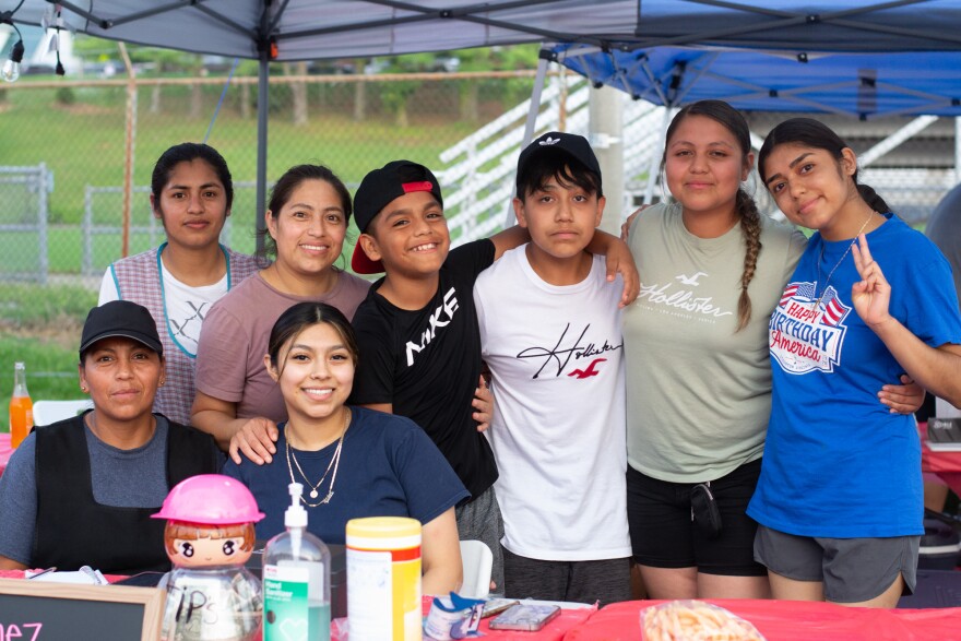 The Martinez Kitchen crew poses for a photo. Ytsel Gomez Martinez is seated, second from the left.