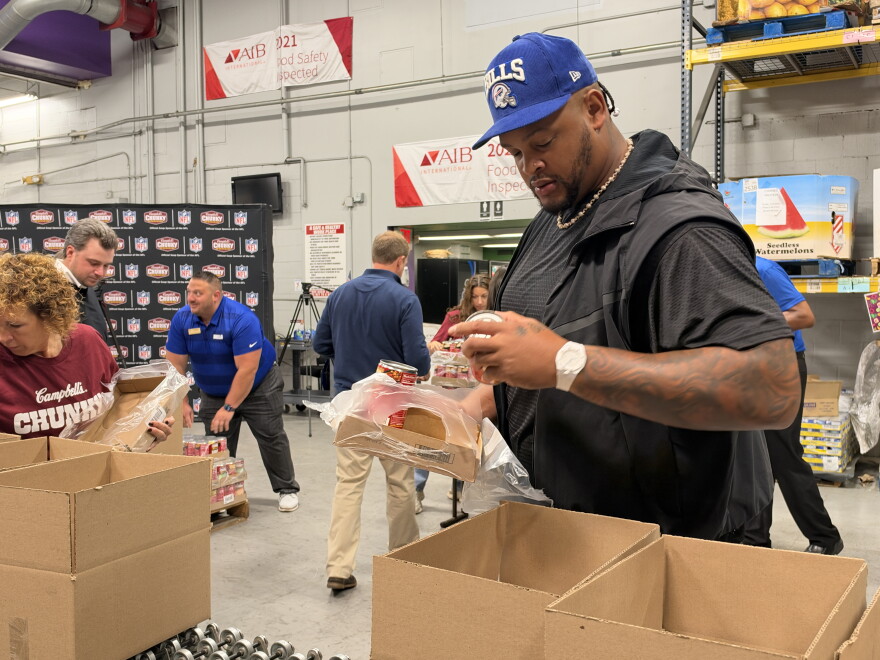 Dion Dawkins packing soup for the community at Feedmore WNY.