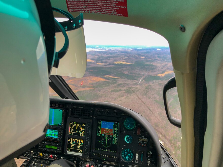 The virtual reality system uses a clear plastic film strapped to the pilot's helmet. Seen here, Jonathan Johnson's view is obscured by "clouds." What the pilot "sees" is controlled by an iPad.