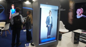 Visitors try an AI assistant at the Europelargest artificial intelligence event, AI Week 2026, in Rho, near Milan, Italy, Tuesday, May 19, 2026.