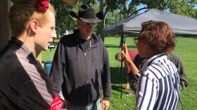 Andrea Fahey (left) listens as Second Chance Village property owner Sage Lewis (center) and Councilwoman Tara Samples (right) discuss the possibility of making vacant houses -- which are slated for demolition -- available to homeless people.