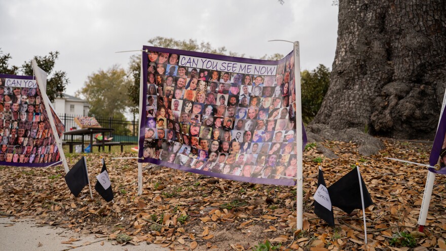 A sign displays the images of people who died from fatal opioid overdoses in Mississippi at Black Balloon Day in Biloxi, Mississippi, on Friday, March 6, 2026