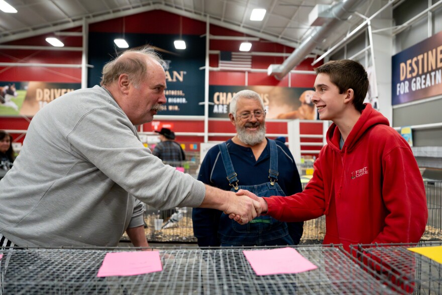 Teddy Brinkmann, of Washington, Mo., right, is congratulated for winning reserve champion with one of his pigeons during the Spirit of St. Louis Winter Pigeon Show at Purina Farms on Saturday, Jan. 10, 2026, in Gray Summit, Mo.