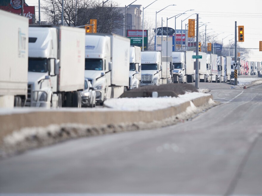 A line of trucks waits for the road to the Ambassador Bridge border crossing in Windsor, Ontario, to reopen February 8 after protesters blocked the road Monday.
