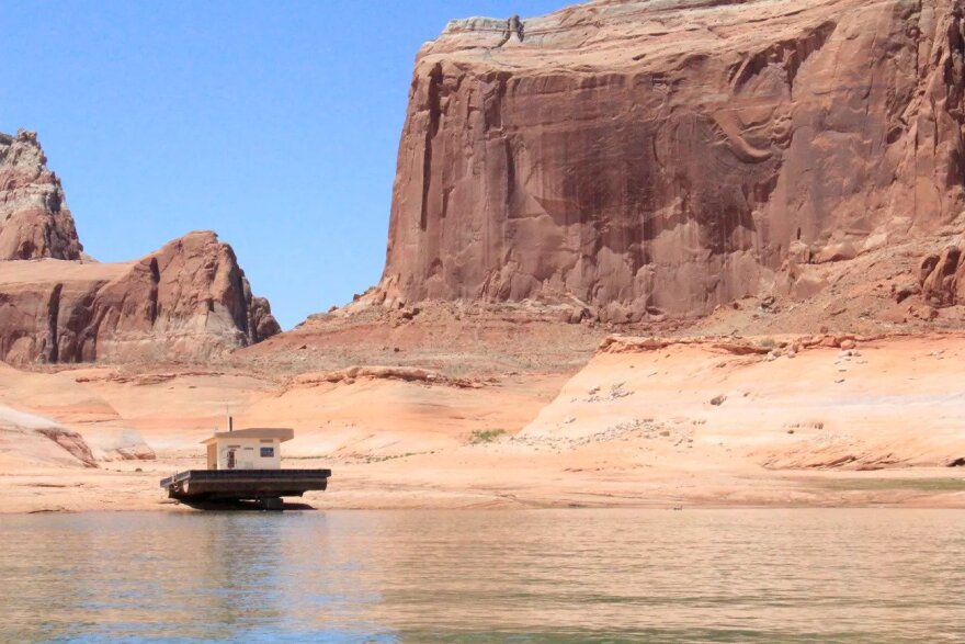 A floating restroom is stranded on rock amid historically low levels at Lake Powell. The bathroom, once located near Dominguez Butte, was moved to deeper water in June 2021.