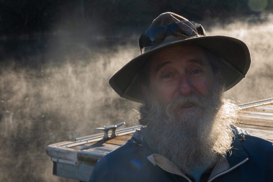 Close-up of a man with a hat and gray beard