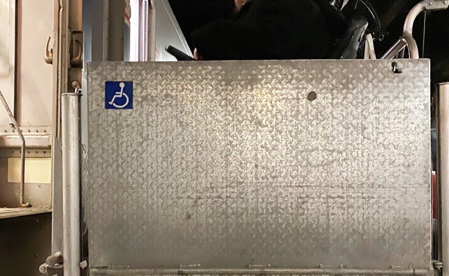 Adam Ballard, of the disability service and advocacy group Access Living, uses a wheelchair lift at Chicago's Union Station to board a train to Bloomington-Normal, to attend a statewide disability conference.