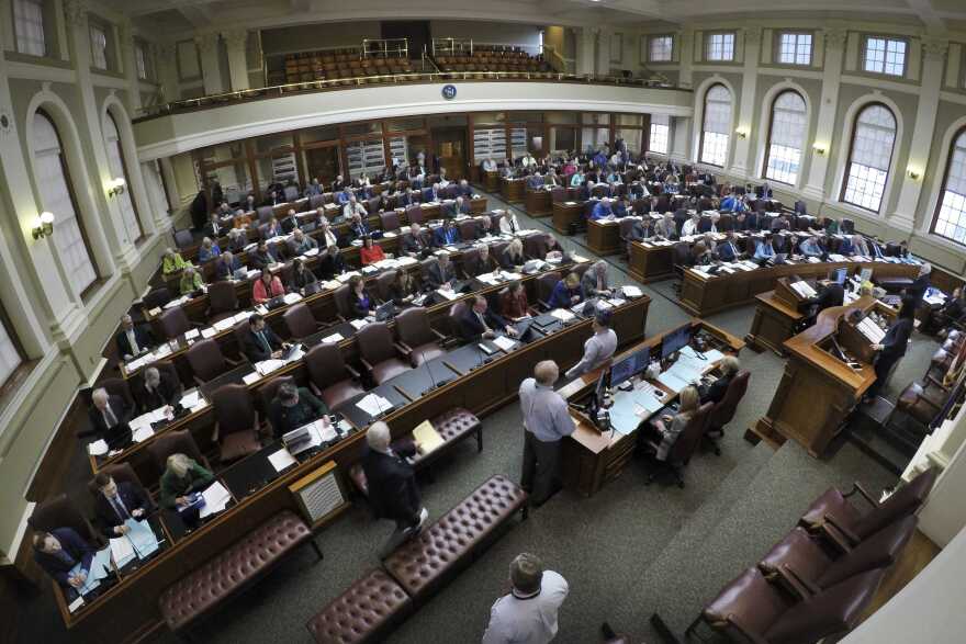 Lawmakers convene in the House Chamber at the State House, Tuesday, March 17, 2020, in Augusta, Maine. The Maine Legislature is considering coronavirus-related legislation and a budget bill. (AP Photo/Robert F. Bukaty)