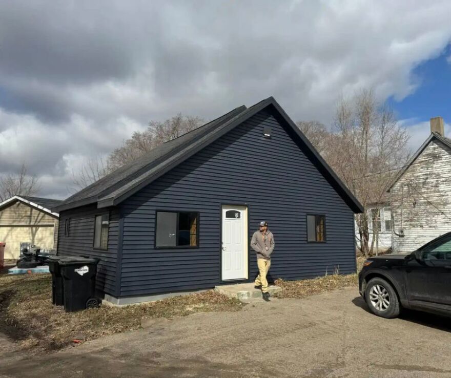 Danny Dejarlais in front of a remodeled home on the reservation. The walls are now insulated with hempcrete | MPR News