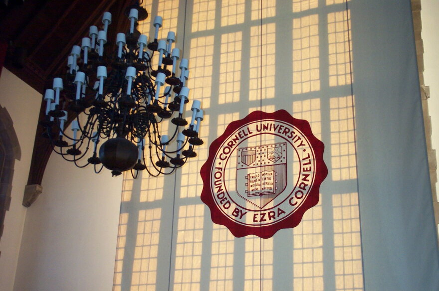 A woman walks by a Cornell University sign on the Ivy League school's campus in Ithaca, New York, on Jan. 14, 2022.
