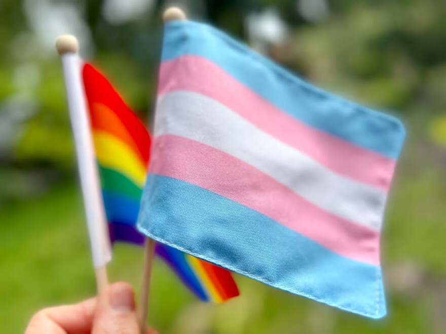FILE - The rainbow flag, also known as the gay pride flag, is a symbol of LGBT and queer pride, left, along with the transgender flag, right, pictured in 2022.