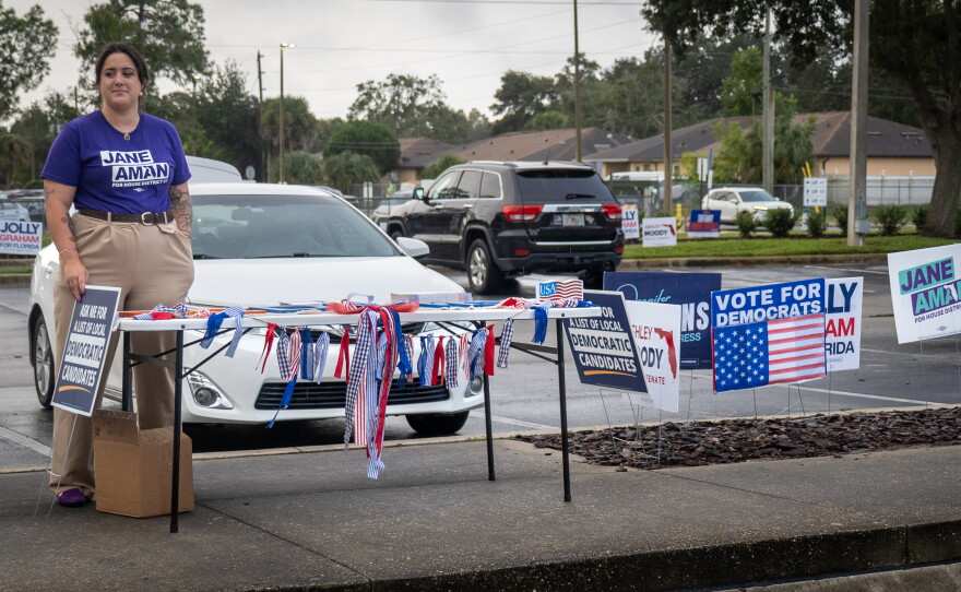 Jane Aman greets voters outside the Alafaya Library Branch early voting site in Orange County on Monday, Oct. 19, 2026. Aman is running as a Democrat for Florida’s 37th district in the state House of Representatives.