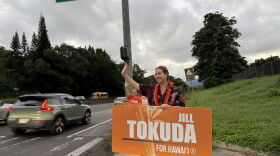 U.S. Rep. Jill Tokuda waves at morning commuters in Kāneʻohe, Hawaii on Monday, Oct. 26, 2026.