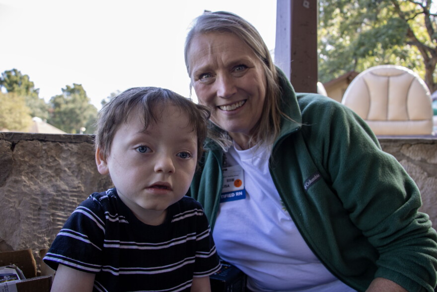 Six-year-old Ryan Norris takes a photo with his nurse Lisa McLeod from his time in the NICU.