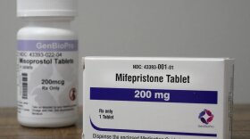 Containers of mifepristone and misoprostol — medications used to end a pregnancy — sit on a table inside of a Planned Parenthood clinic in Fairview Heights, Ill.