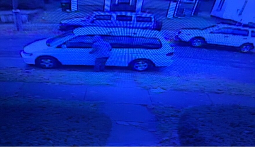Surveillance video still of the suspect getting into the van.