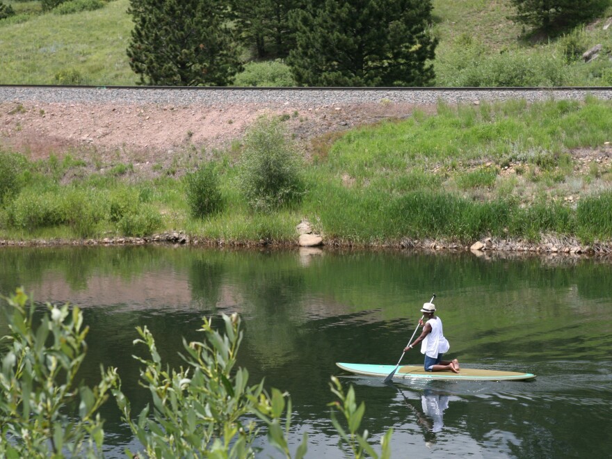 Gary Jackson's wife, Regina, paddleboarding on Pactolus Lake in Lincoln Hills.
