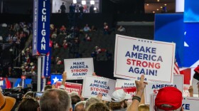 Members of Michigan's delegation holds up signs saying "Make America Strong Again" at the 2024 Milwaukee
