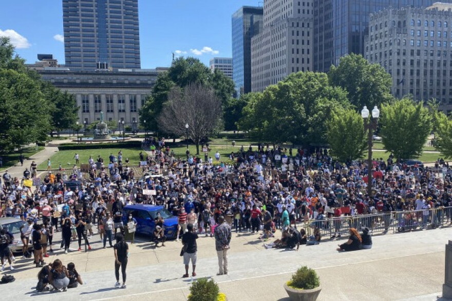 A few hundred protesters gather at the Indiana War Memorial after marching from the Indiana Statehouse. The demonstration is also working to register people to vote.