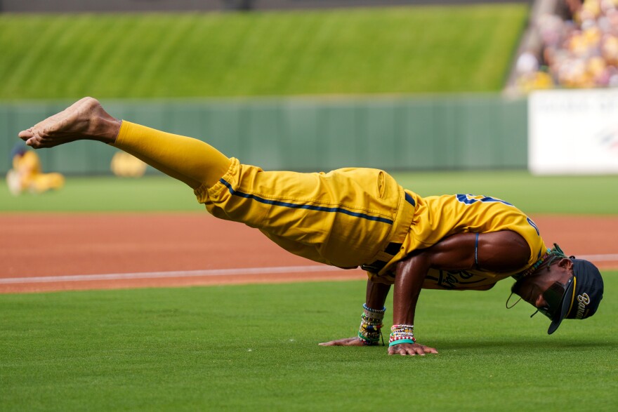 Savannah Banana first base coach Maceo Harrison does a handstand ahead of the game between the Savannah Bananas and the Party Animals at Busch Stadium on Friday, July 18, 2025, in downtown St. Louis.