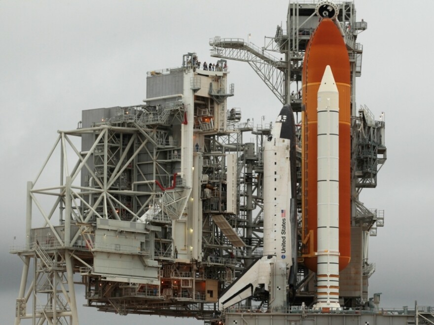 The Rotating Service Structure (L) swings back to reveal the space shuttle Atlantis at Kennedy Space Center, Cape Canaveral, Florida, on July 7, 2011. The U.S. space program has served as a source of inspiration to generations of Americans.