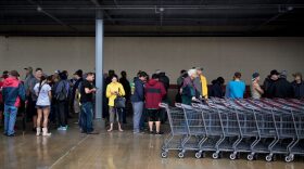 People wait in line for an H-E-B grocery store to open during the aftermath of Hurricane Harvey on Aug. 29, 2017 in Deer Park, Texas. (Brendan Smialowski/AFP/Getty Images)