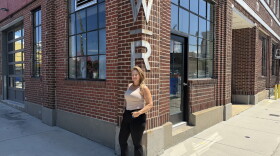 Careyann Weinberg, former director of Work|Release, outside the Texaco building in Norfolk's NEON District under the venue's original signage.