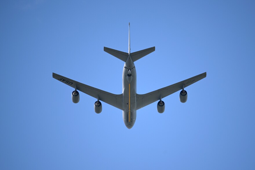A U.S. Air Force KC-135 Stratotanker aerial refueling aircraft performs a flyover during the national anthem before an NCAA college football game.