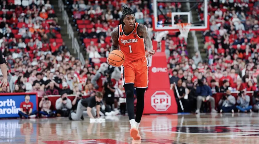 Donnie Freeman (1, Orange) directs traffic from the wing against NC State on Tuesday in the Lenovo Center.