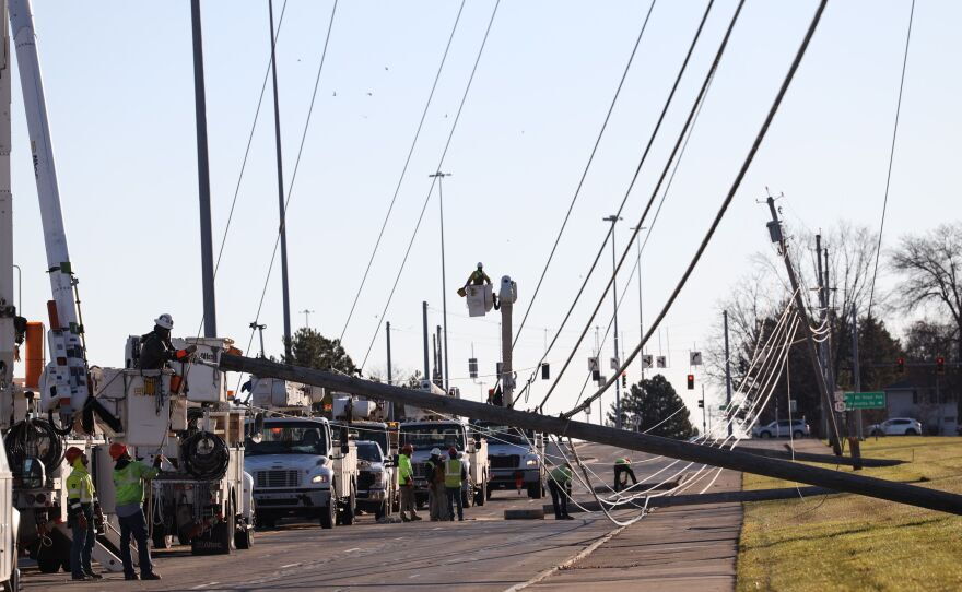 Power crews work to restore power Saturday.