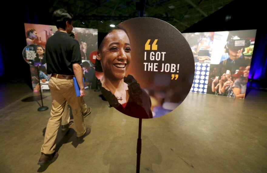 In this Friday, May 19, 2017, file photo, job seekers walk into the Opportunity Fair and Forum employment event in Dallas. On Friday, Nov. 18, 2022, the the Texas Workforce Commission announced the state added nearly 50,000 nonfarm jobs.