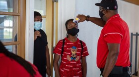 Students who attend the summer enrichment program in Jennings, Mo., have their temperature taken upon arrival.