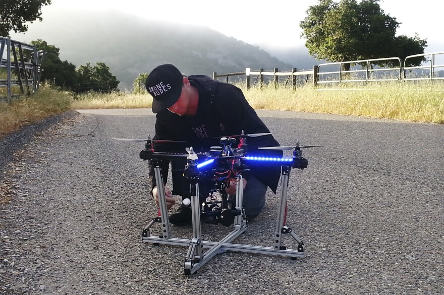 Jeff Blank, of Los Angeles-based Drone Dudes, prepares a quadcopter for takeoff. The drone has to chase a motorcycle down a hill.